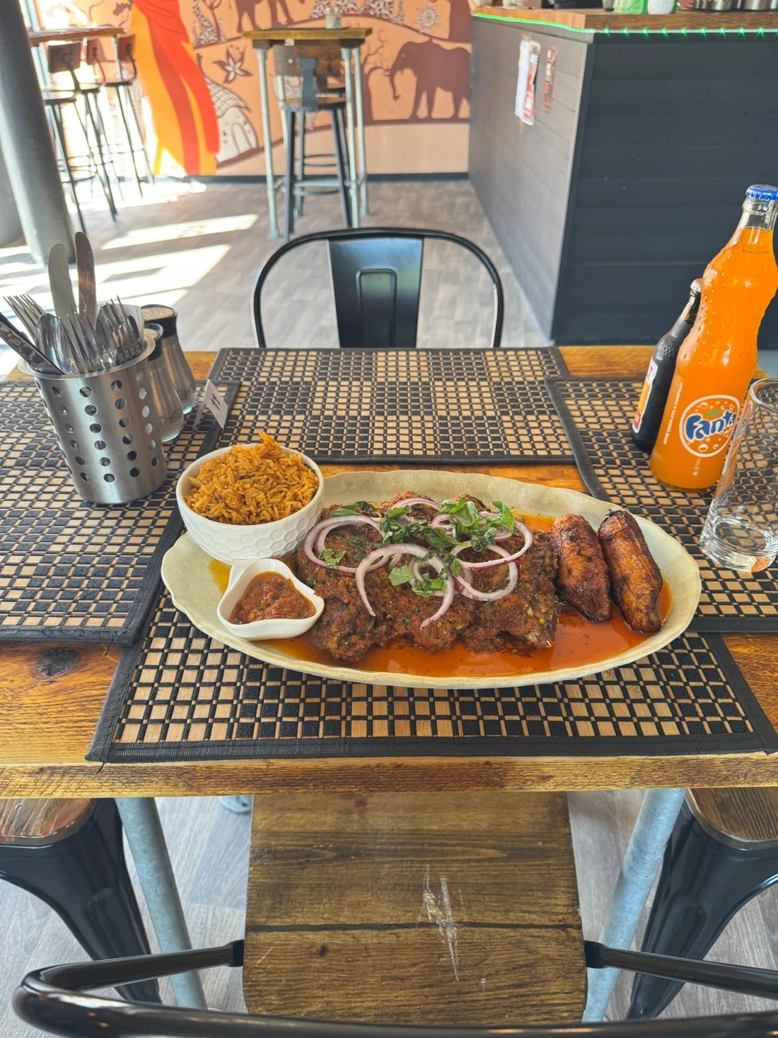 KC’s jerk turkey wing sharing platter with jollof rice, plantain, salad and sauce.